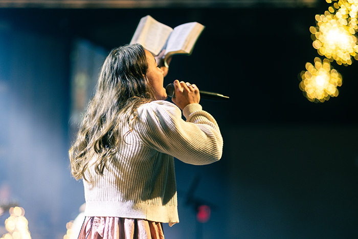 Worship leader holding Bible